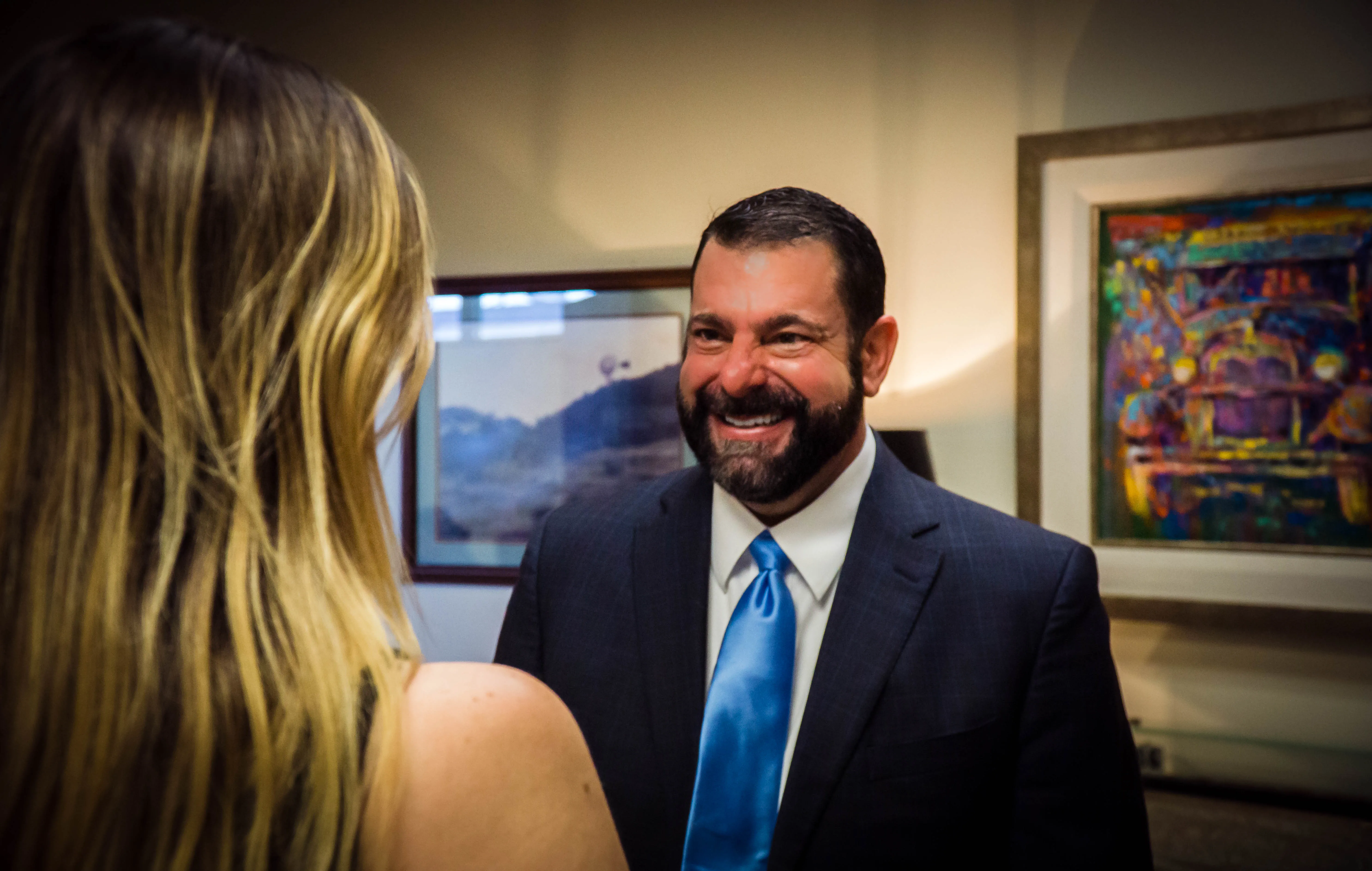 Cody Pirtle speaking to a woman.